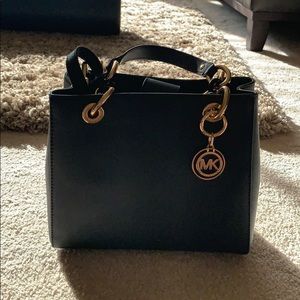 Black Michael Kors purse with gold and black chain